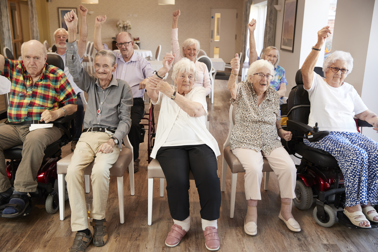 Happy seniors in a retirement home playing a game